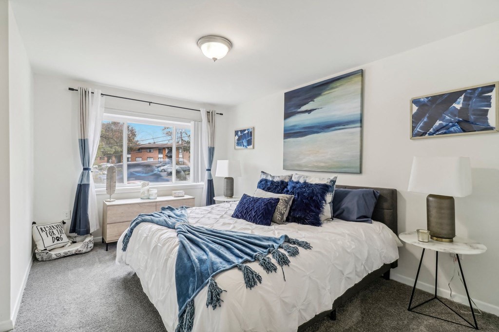 a bedroom with a bed and a large window at Oaks at Oxon Hill, Oxon Hill, Maryland