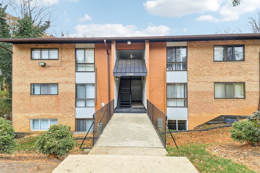 the front entrance of a brick apartment building at Oaks at Oxon Hill, Oxon Hill, Maryland