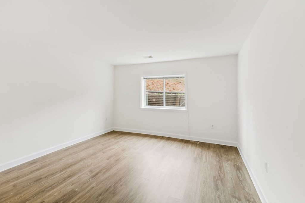 an empty room with white walls and a window at Oaks at Oxon Hill, Oxon Hill, Maryland