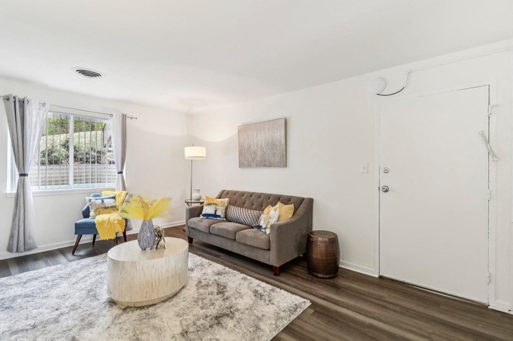 a living room with a couch and a round coffee table at Oaks at Oxon Hill, Oxon Hill, Maryland