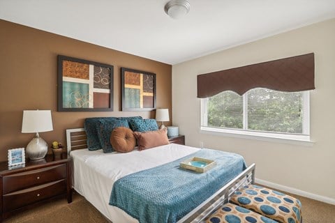 a bedroom with a bed and a window at Andrews Ridge Apartments, Suitland, MD