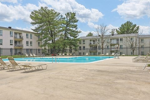 our apartments have a resort style pool with lounge chairs at Andrews Ridge Apartments, Suitland, MD