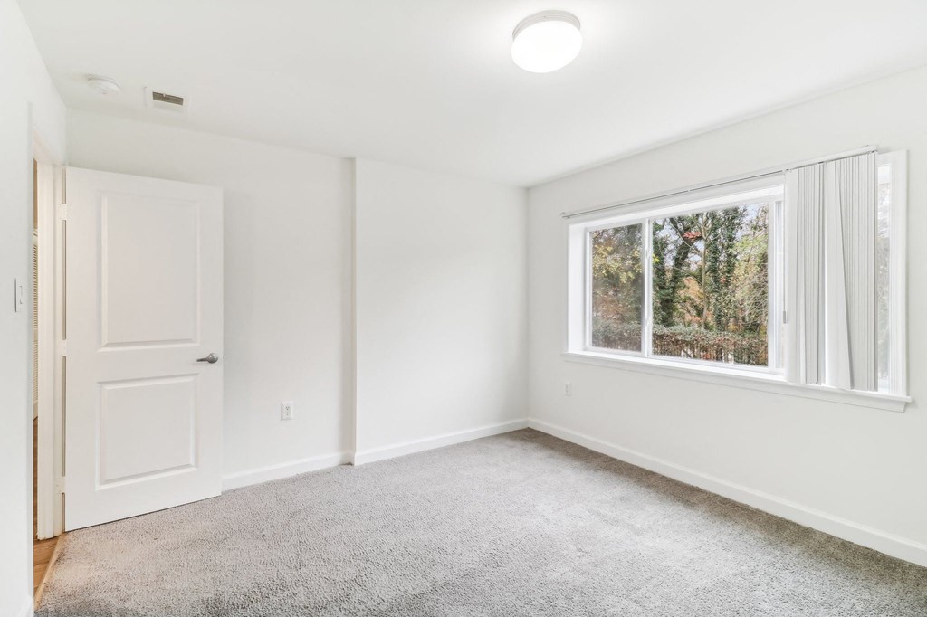 an empty room with a window and a door at Oaks at Oxon Hill, Oxon Hill, Maryland