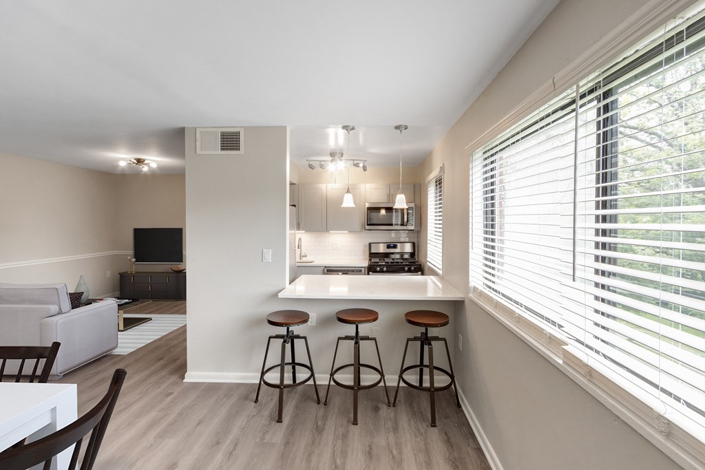 kitchen with a bar and stools at Flats of Forestville, Forestville, Maryland 20747