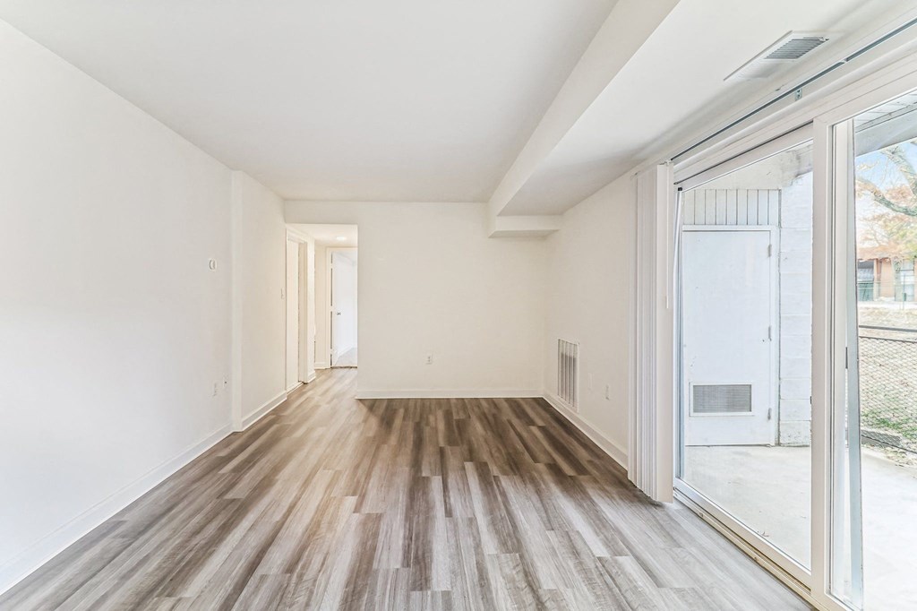 a living room with wood floors and a large glass door at Oaks at Oxon Hill, Oxon Hill, Maryland