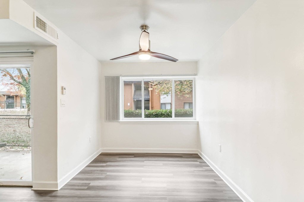 an empty room with a window and a ceiling fan at Oaks at Oxon Hill, Oxon Hill, Maryland