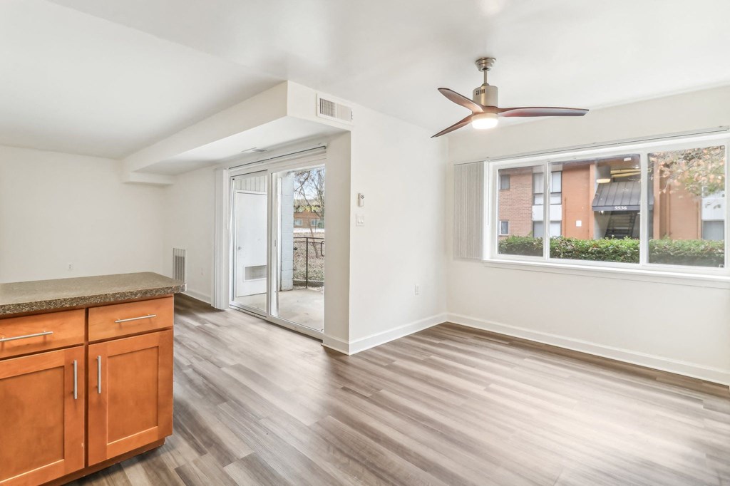 a living room with a ceiling fan and a door to a patio at Oaks at Oxon Hill, Oxon Hill, Maryland