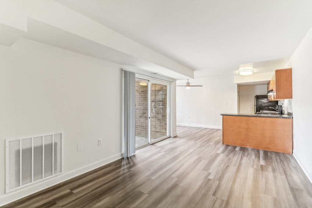a living room with a wood floor and a sliding glass door at Oaks at Oxon Hill, Oxon Hill, Maryland