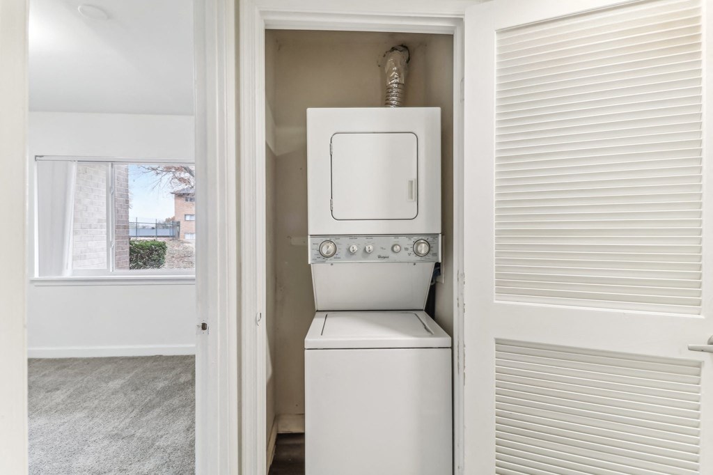 a laundry room with a washer and dryer and a window at Oaks at Oxon Hill, Oxon Hill, Maryland