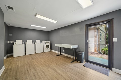 A laundry room with a washer and dryer set up next to each other.