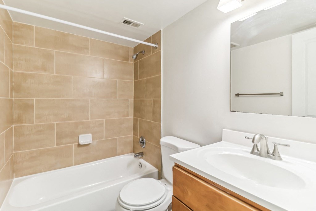 a bathroom with a sink toilet and bath tub at Oaks at Oxon Hill, Oxon Hill, Maryland