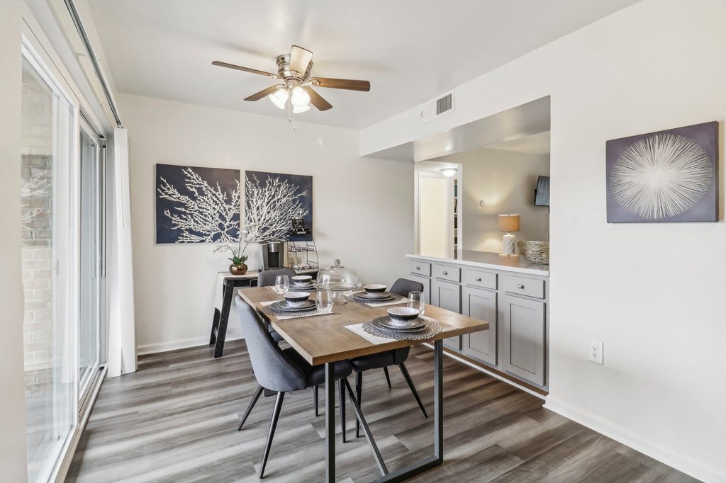 a dining room with a table and a ceiling fan at Oaks at Oxon Hill, Oxon Hill, Maryland