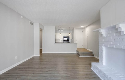 A modern living room with a fireplace and a flat screen TV at The Onyx Hoover Apartments, Hoover, Alabama