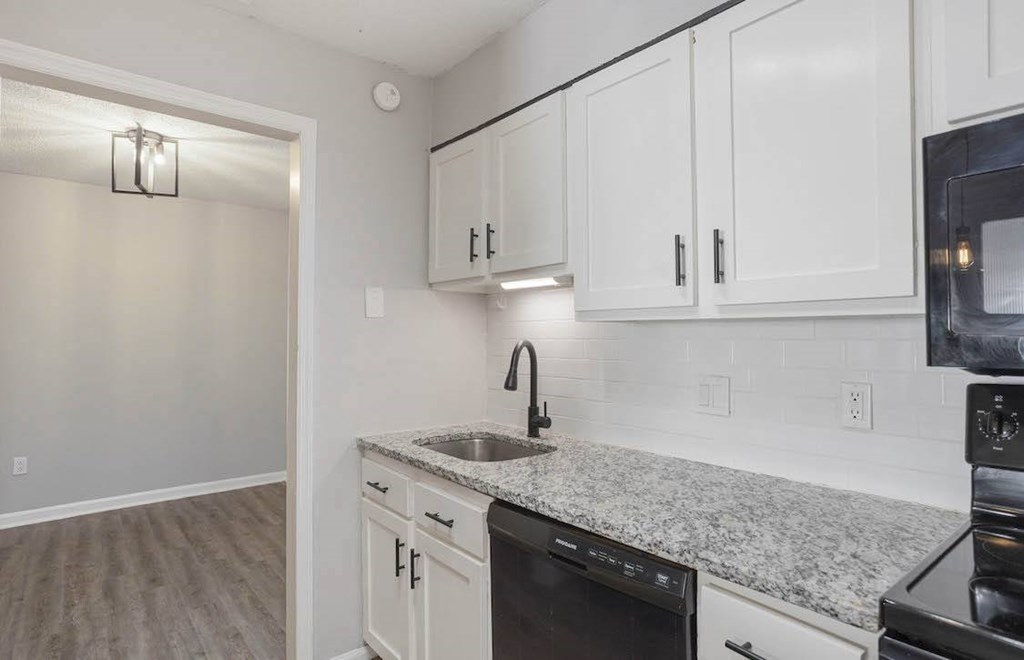 A kitchen with white cabinets and a granite countertop. A kitchen with white cabinets and a granite countertop at The Onyx Hoover Apartments, Alabama, 35216