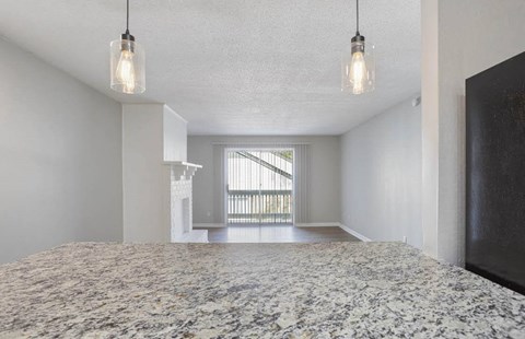 A bedroom with a large bed and a window with blinds at The Onyx Hoover Apartments, Alabama