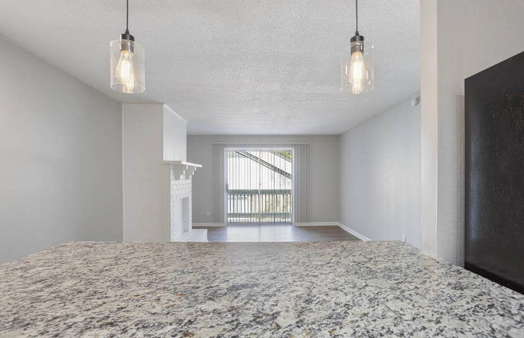 A bedroom with a large bed and a window with blinds. A bedroom with a large bed and a window with blinds at The Onyx Hoover Apartments, Alabama