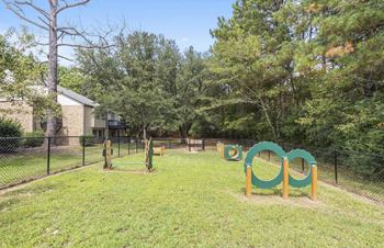 A playground with a green and yellow swing set at The Onyx Hoover Apartments, Hoover, AL