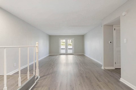 A spacious room with light wood flooring and white walls. at The Onyx Hoover Apartments, Hoover, AL, 35216