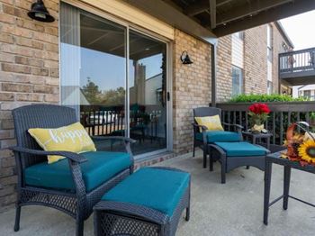 A patio with a chair and a table at The Onyx Hoover Apartments, Hoover, Alabama