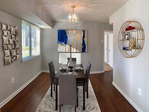 a dining room with a table and chairs at The Glendale Residence, Lanham, 20706