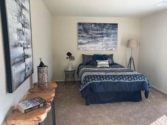 a bedroom with a bed and a nightstand - Photo Gallery 2