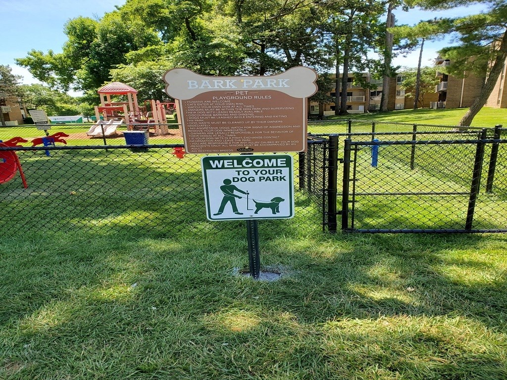 a sign in front of a park with a playground in the background at The Glendale Residence, Maryland, 20706