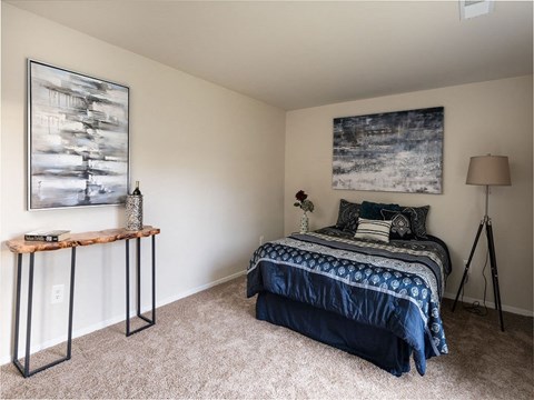 a bedroom with a bed and two paintings on the wall at The Glendale Residence, Lanham, MD, 20706