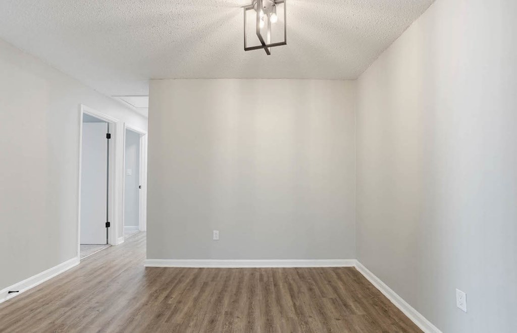 A room with a wooden floor and a light fixture on the ceiling. A room with a wooden floor and a light fixture on the ceiling at The Onyx Hoover Apartments, Hoover, AL