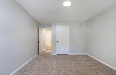 A long, empty hallway with carpeted floors and white walls at The Onyx Hoover Apartments, Hoover, 35216