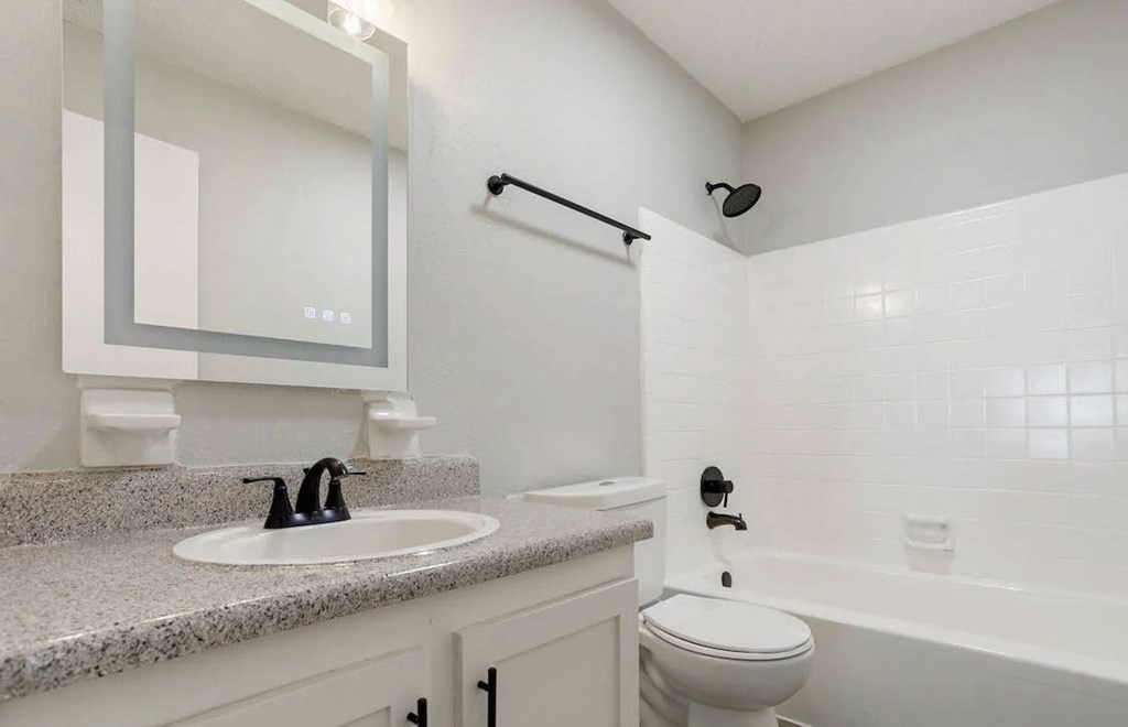 A white bathroom with a sink, toilet, and bathtub. A white bathroom with a sink, toilet, and bathtub at The Onyx Hoover Apartments, Hoover, 35216
