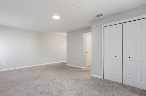 A spacious room with a carpeted floor and white walls at The Onyx Hoover Apartments, Alabama