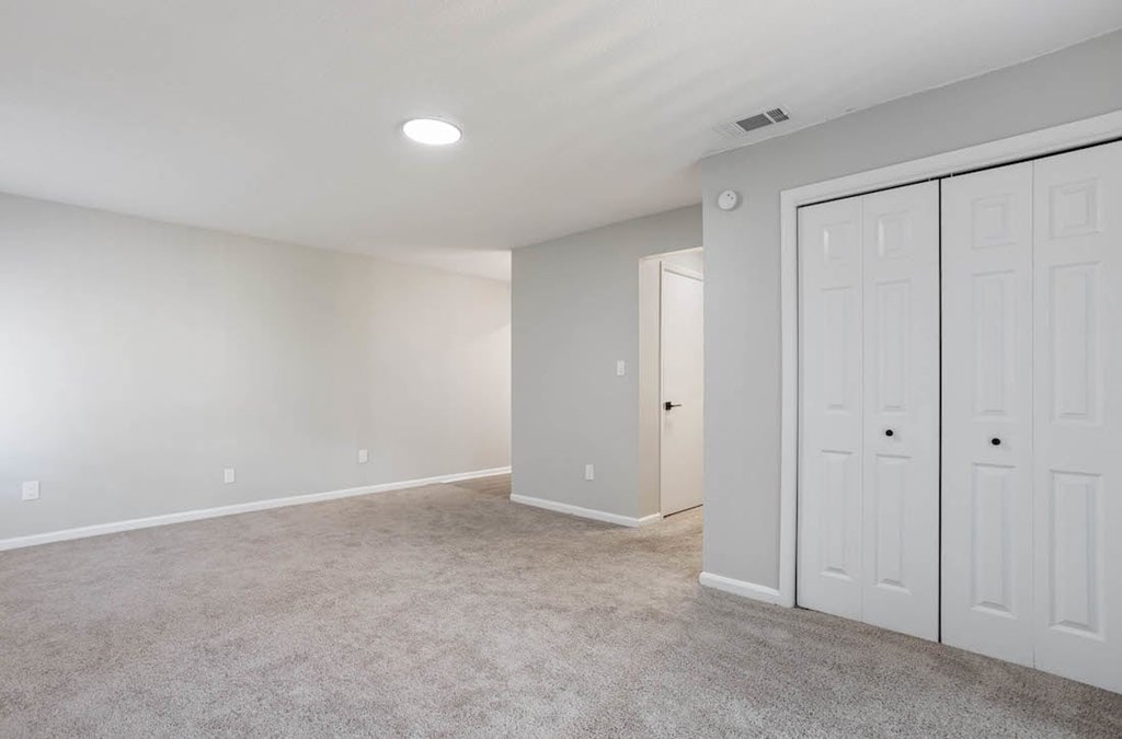 A spacious room with a carpeted floor and white walls. A spacious room with a carpeted floor and white walls at The Onyx Hoover Apartments, Alabama