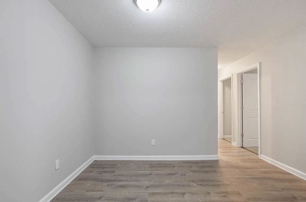 A room with a light on ceiling and a door on the right. A room with a light on ceiling and a door on the right at The Onyx Hoover Apartments, Hoover, AL, 35216