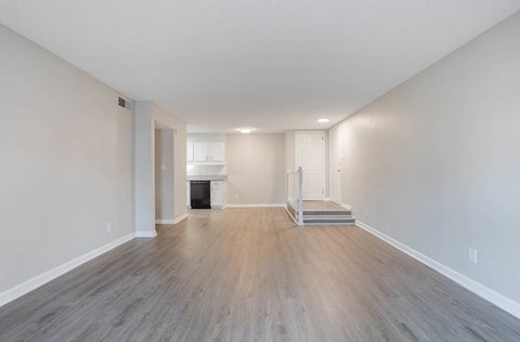 A spacious room with wood flooring and a fireplace at The Onyx Hoover Apartments, Hoover, AL, 35216
