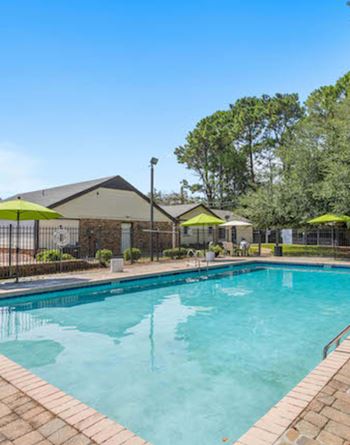 A swimming pool surrounded by a brick border at The Onyx Hoover Apartments, Hoover, AL, 35216
