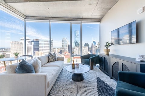 A modern living room with a view of the city skyline.