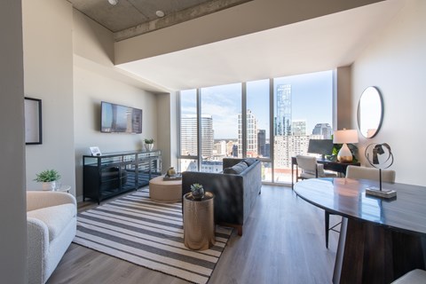 A modern living room with a large window overlooking the city.