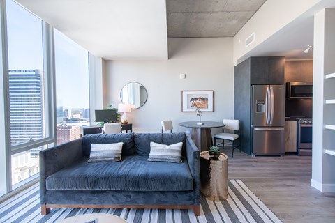 A modern living room with a large window overlooking the city.