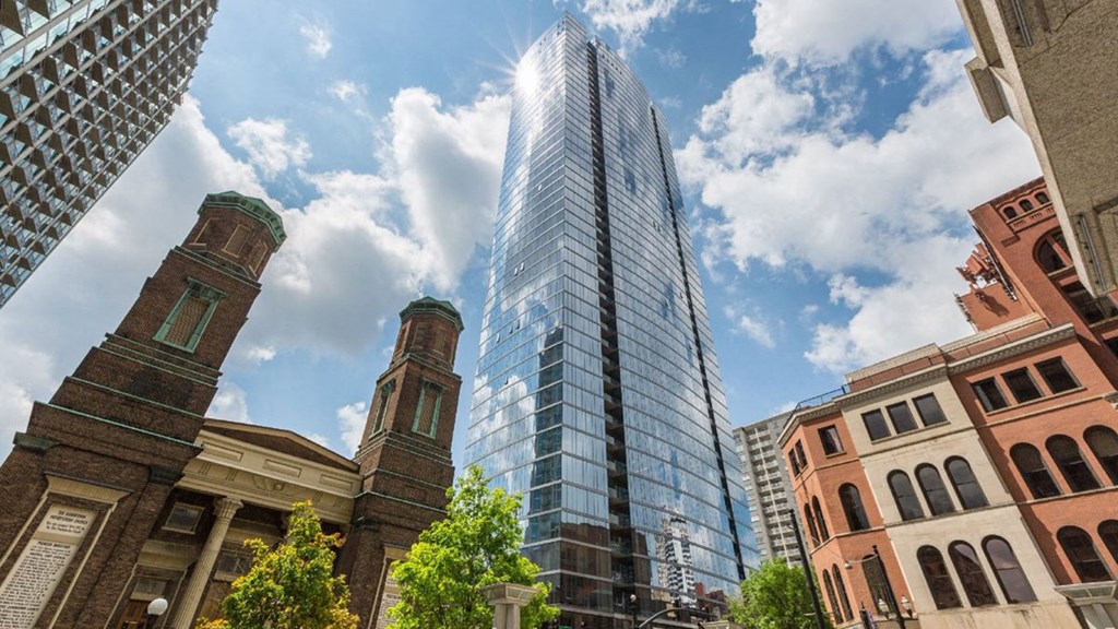 a tall skyscraper in a city with other tall buildings