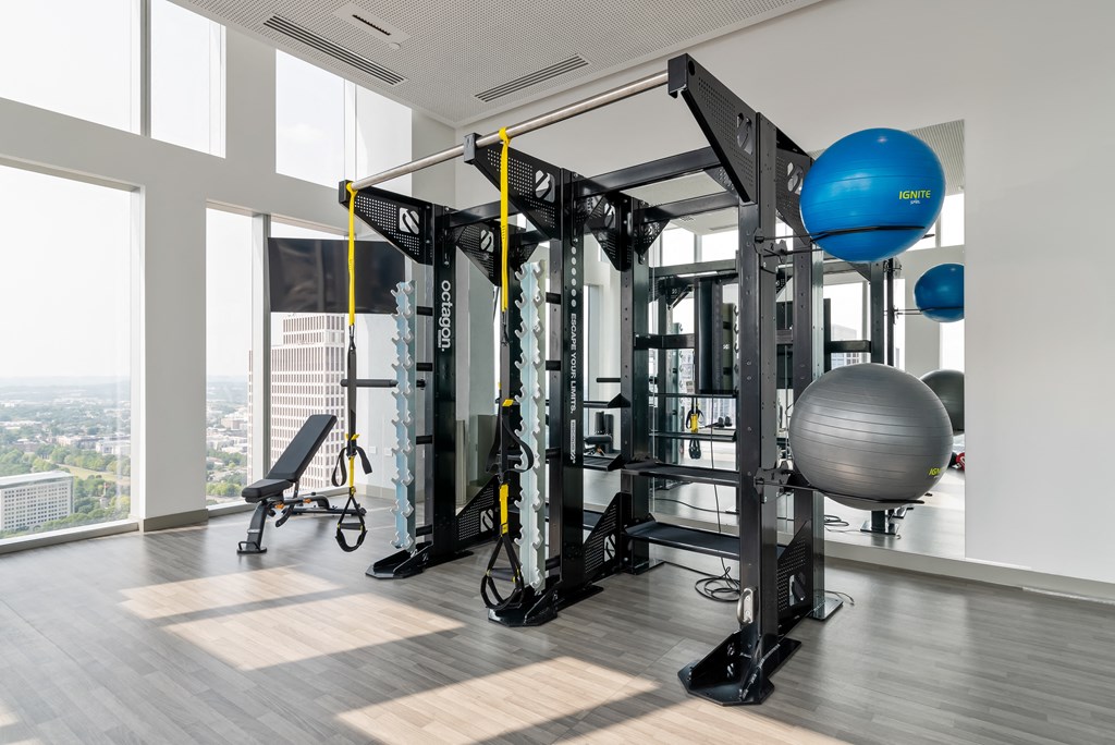 a gym with exercise equipment and a large window