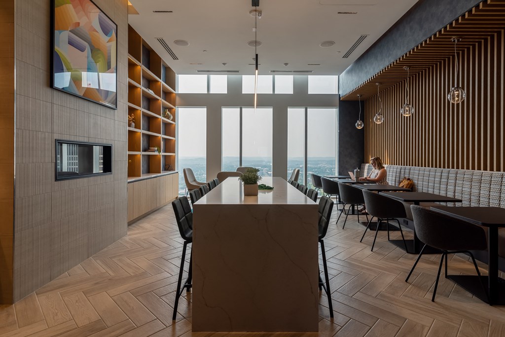 a dining room with a table and chairs and a view of the ocean