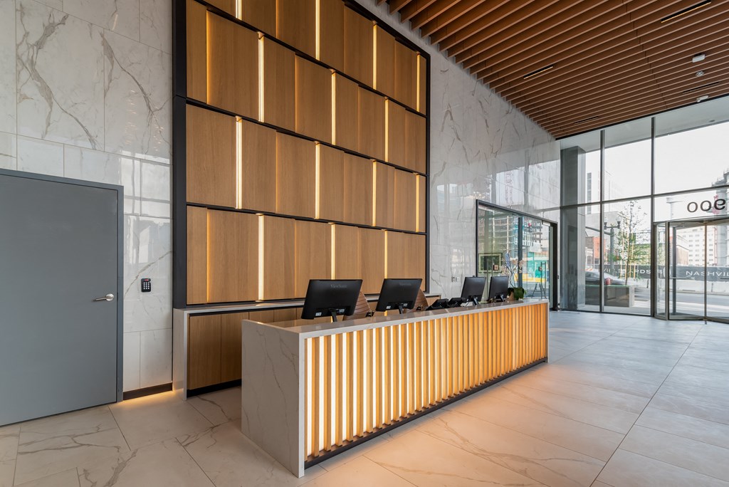 a reception area with a wooden desk and a large window