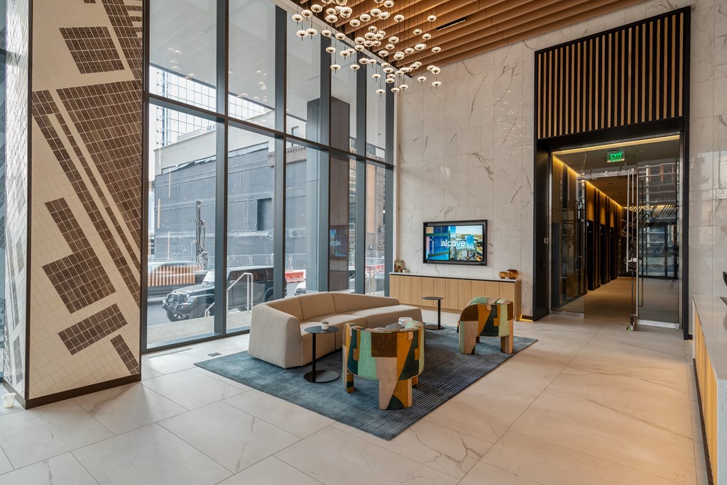 the lobby of a hotel with a couch and a tv