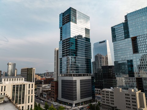 A cityscape with tall buildings and a mix of modern and older architecture.