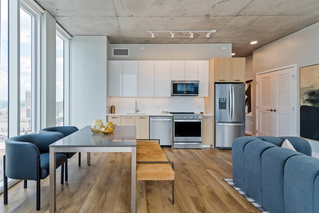 a kitchen and living room with a table and chairs