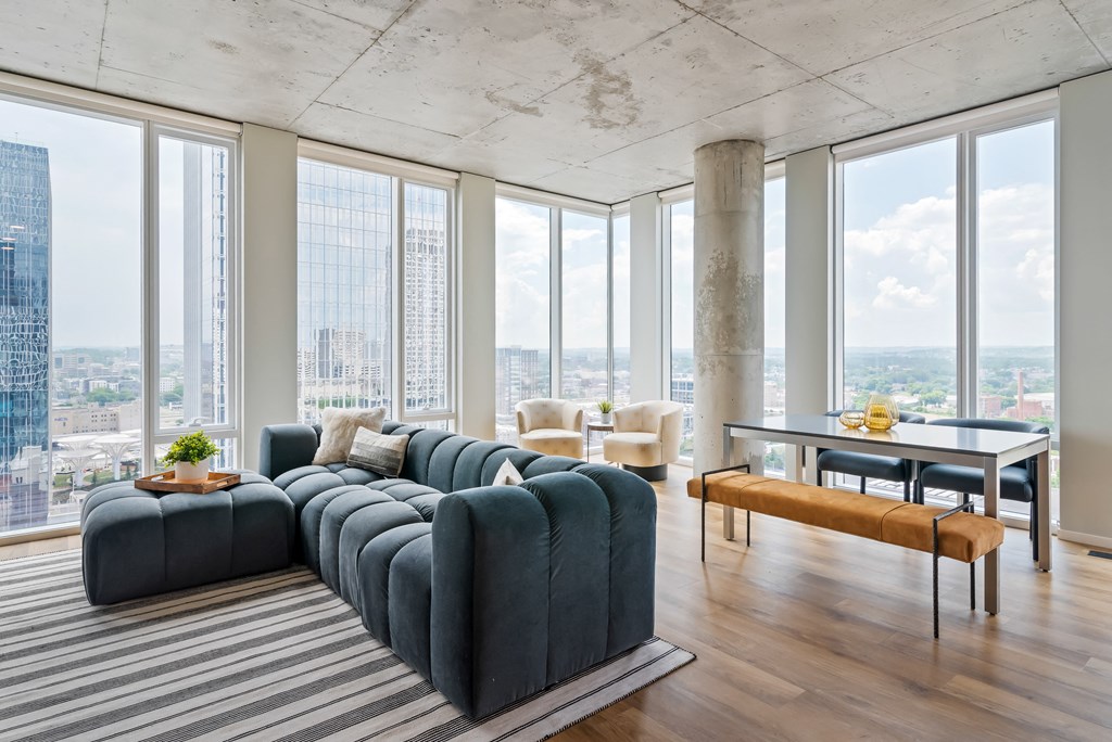 a living room with a blue couch and a view of the city