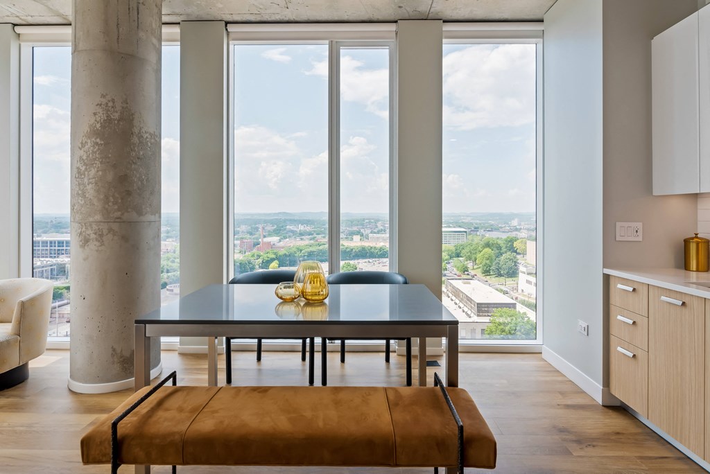 a dining room with a table and a view of the city