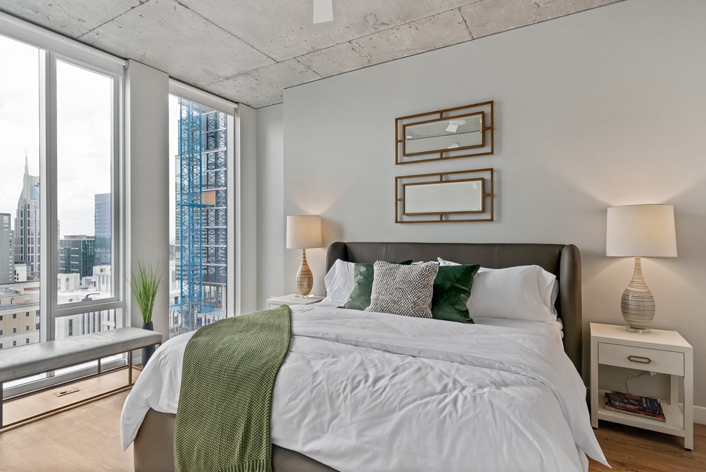 a bedroom with a large bed and a large window