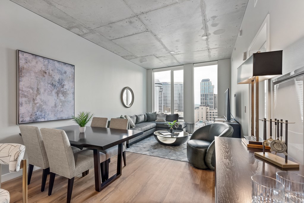 a living room with a dining room table and a couch