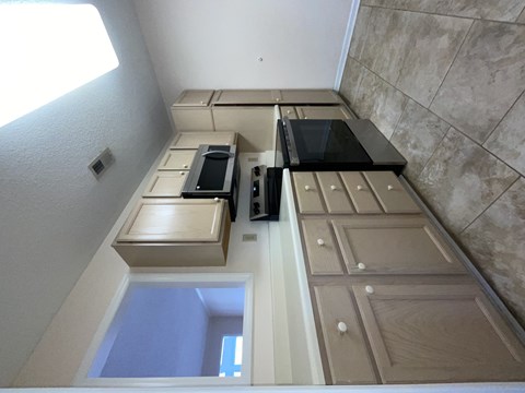 A kitchen with a stove top oven and microwave.